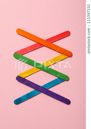 LGBT parade concept, holiday symbols on pink background. LGBT parade concept, holiday symbols on pink background. 115397332