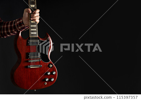 A man plays a beautiful guitar close-up A man plays a beautiful guitar close-up 115397357