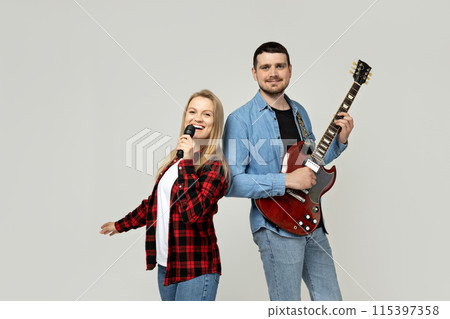 Young man and woman playing the guitar Young man and woman playing the guitar 115397358