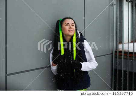 Woman With Green Hair Standing Against a Wall Woman With Green Hair Standing Against a Wall 115397710