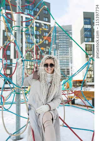 Woman Sitting on Top of Metal Structure Woman Sitting on Top of Metal Structure 115397734