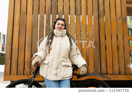 Woman With Dreadlocks Standing Next to a Bike Woman With Dreadlocks Standing Next to a Bike 115397738