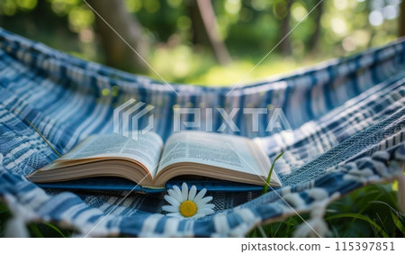 Open Book Resting on a Hammock in a Forest Setting 115397851