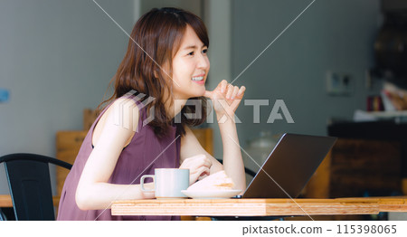 A woman making a meeting at a cafe A woman making a meeting at a cafe 115398065