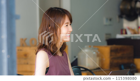 A woman making a meeting at a cafe A woman making a meeting at a cafe 115398080