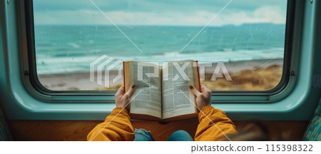 Person Reading a Book on a Train With an Ocean View Person Reading a Book on a Train With an Ocean View 115398322