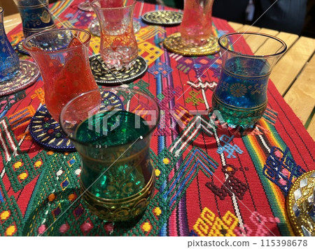 Colorful glasses on a colorful rug Colorful glasses on a colorful rug 115398678