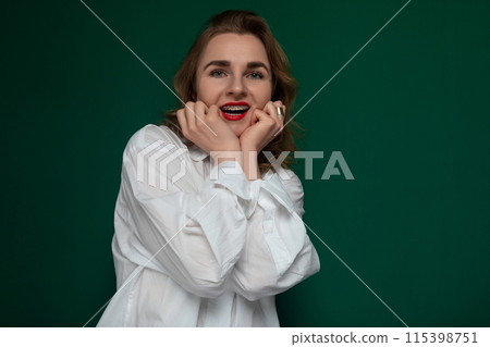 Woman in White Shirt Posing With Hands on Face Woman in White Shirt Posing With Hands on Face 115398751