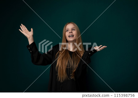 Woman Standing in Front of Green Wall Woman Standing in Front of Green Wall 115398756