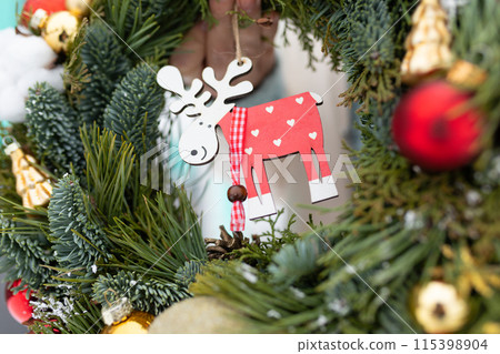 Close Up of a Christmas Wreath With Reindeer Ornament 115398904