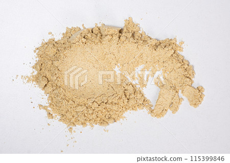 Smear of ground ginger, dry ginger root powder on white background. Smear of ground ginger, dry ginger root powder on white background. 115399846