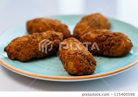 Chicken nuggets in batter on a plate 115400598