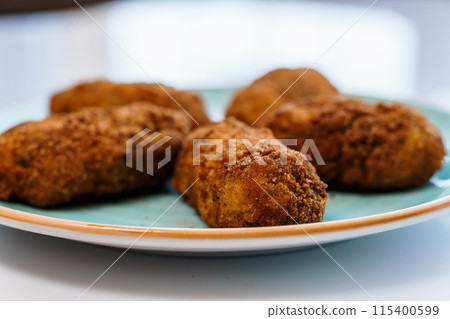 Chicken nuggets in batter on a plate Chicken nuggets in batter on a plate 115400599