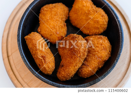 Chicken nuggets in batter on a plate 115400602