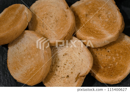 Pate with sauce and croutons on a black board on a white background 115400627