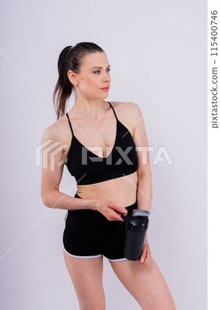 Sporty female drinking water after workout. Photo of fitness woman. Healthy lifestyle 115400746
