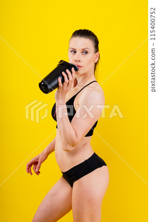 Sporty female drinking water after workout. Photo of fitness woman. Healthy lifestyle Sporty female drinking water after workout. Photo of fitness woman. Healthy lifestyle 115400752