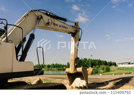 Excavator in a quarry extracting stone, soil ground Excavator in a quarry extracting stone, soil ground 115400792