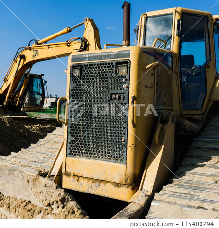 Excavator in a quarry extracting stone, soil ground Excavator in a quarry extracting stone, soil ground 115400794