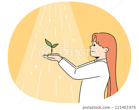 Smiling girl holding green plant in sunlight 115401978