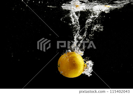 Fresh fruit falling into the water. Organic fruits for making effective juices for dieting. 115402043