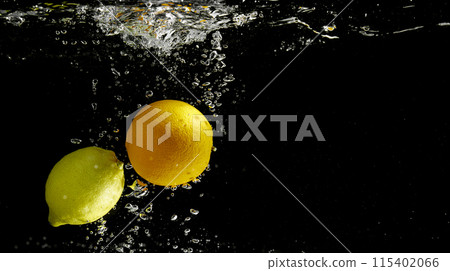 Fresh fruit falling into the water. Organic fruits for making effective juices for dieting. 115402066