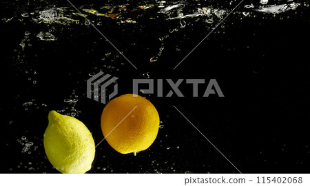 Fresh fruit falling into the water. Organic fruits for making effective juices for dieting. 115402068