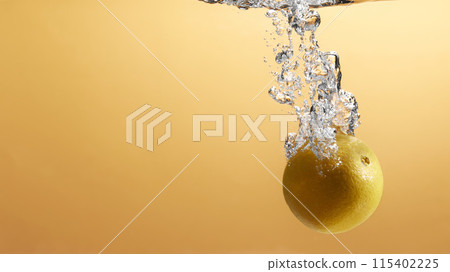 Fresh fruit falling into the water. Organic fruits for making effective juices for dieting. 115402225