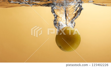 Fresh fruit falling into the water. Organic fruits for making effective juices for dieting. 115402226