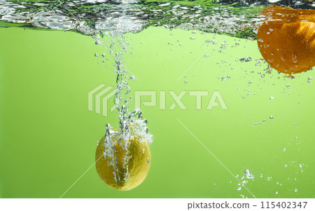 Fresh fruit falling into the water. Organic fruits for making effective juices for dieting. 115402347