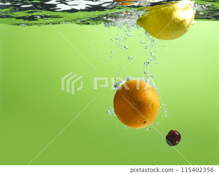 Fresh fruit falling into the water. Organic fruits for making effective juices for dieting. Fresh fruit falling into the water. Organic fruits for making effective juices for dieting. 115402356