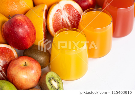 Different fruit juices in glasses on white background 115403910