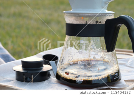 Brewing coffee outdoors on the lawn Brewing coffee outdoors on the lawn 115404182