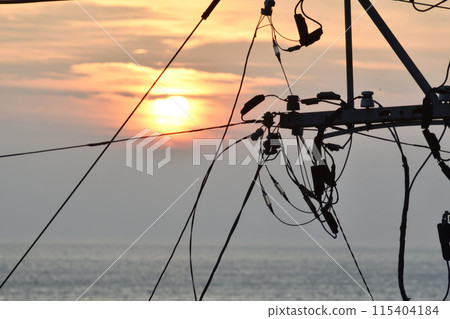 Sunset and electric wire 115404184