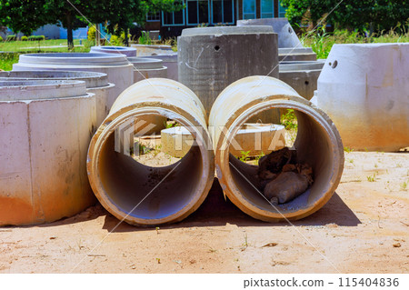 Concrete drainage wells for water discharge on construction site before they are installed 115404836