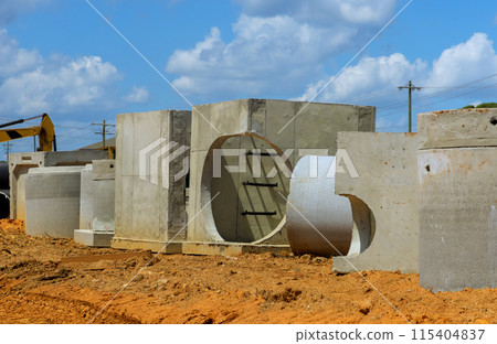 Stack of concrete drainage wells for water discharge in aconstruction site prior to their installation Stack of concrete drainage wells for water discharge in aconstruction site prior to their installation 115404837