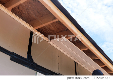 Installation polyvinyl soffit at roof corners of house with rafters Installation polyvinyl soffit at roof corners of house with rafters 115404842
