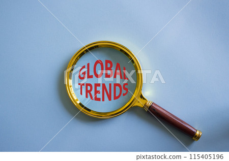 Global Trends symbol. Magnifying glass with words Global Trends. Beautiful blue background. Business and Global Trends concept. Copy space. 115405196