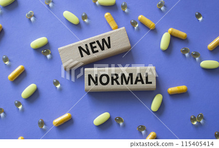 New normal symbol. Wooden blocks with words New normal. Beautiful purple background with pills. Medicine and New normal concept. Copy space. New normal symbol. Wooden blocks with words New normal. Beautiful purple background with pills. Medicine and New normal concept. Copy space. 115405414