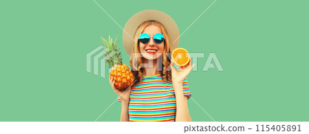 Summer portrait of happy smiling young woman with pineapple fruits tourist hat on green background Summer portrait of happy smiling young woman with pineapple fruits tourist hat on green background 115405891