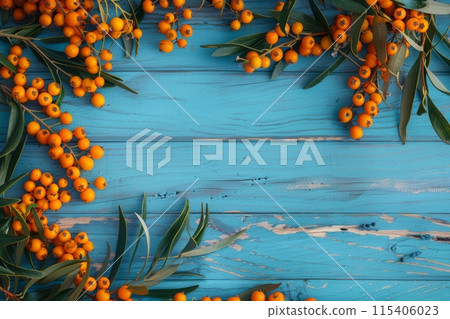 Buckthorn berries on a blue rustic wooden background Buckthorn berries on a blue rustic wooden background 115406023