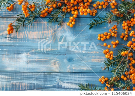 Buckthorn berries on a blue rustic wooden background 115406024