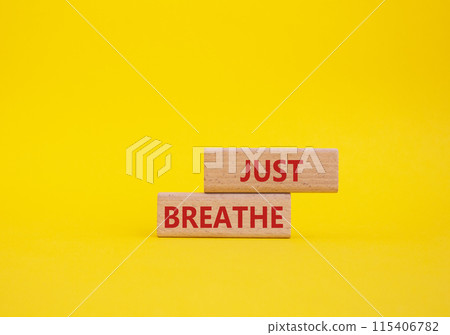 Just Breathe symbol. Wooden blocks with words Just Breathe. Beautiful yellow background. Business and Just Breathe concept. Copy space. 115406782