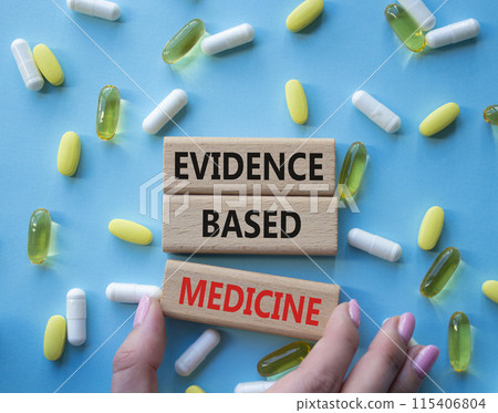 Evidence Based Medicine symbol. Concept word Evidence Based Medicine on wooden blocks. Doctor health. Beautiful blue background with pills. Medicine and Evidence Based Medicine concept. Copy space 115406804