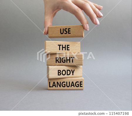 Use the right Body Language symbol. Concept words Use the right Body Language on wooden blocks. Businessman hand. Beautiful grey background. Business concept. Copy space 115407198