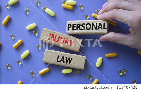 Personal Injury Law symbol. Concept words Personal Injury Law on wooden blocks. Beautiful purple background with pills. Doctor hand. Healthcare and Personal Injury Law concept. Copy space. Personal Injury Law symbol. Concept words Personal Injury Law on wooden blocks. Beautiful purple background with pills. Doctor hand. Healthcare and Personal Injury Law concept. Copy space. 115407422