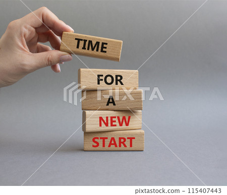 Time for a new start symbol. Wooden blocks with words Time for a new start. Beautiful grey background. Businessman hand. Business and Time for a new start concept. Copy space. Time for a new start symbol. Wooden blocks with words Time for a new start. Beautiful grey background. Businessman hand. Business and Time for a new start concept. Copy space. 115407443