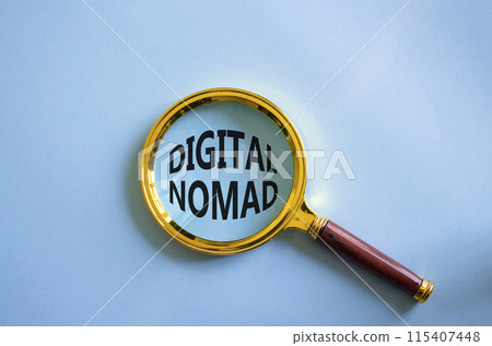 Digital Nomad symbol. Concept word Digital Nomad with Magnifying glass. Beautiful blue background. Business and Digital Nomad concept. Copy space 115407448