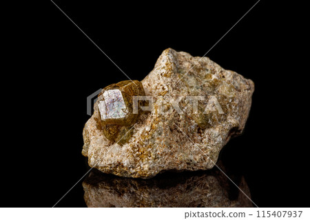 Macro stone Grossular mineral on a black background 115407937