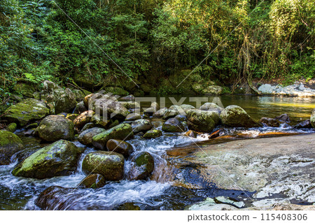 Waterfall between rocks in the rainforest 115408306